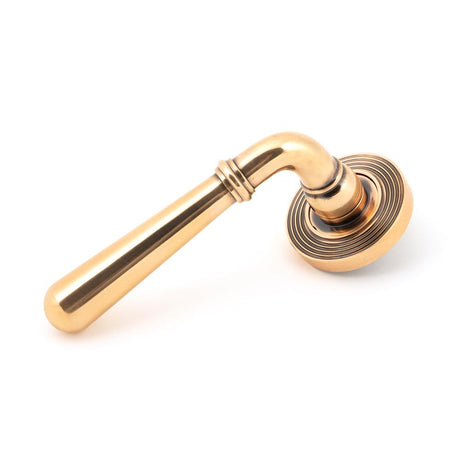 This is an image showing From The Anvil - Polished Bronze Newbury Lever on Rose Set (Beehive) available from trade door handles, quick delivery and discounted prices