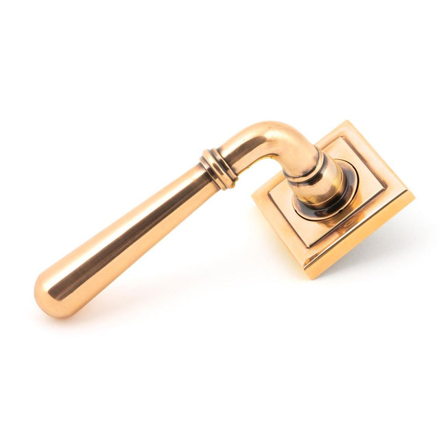 This is an image showing From The Anvil - Polished Bronze Newbury Lever on Rose Set (Square) available from trade door handles, quick delivery and discounted prices