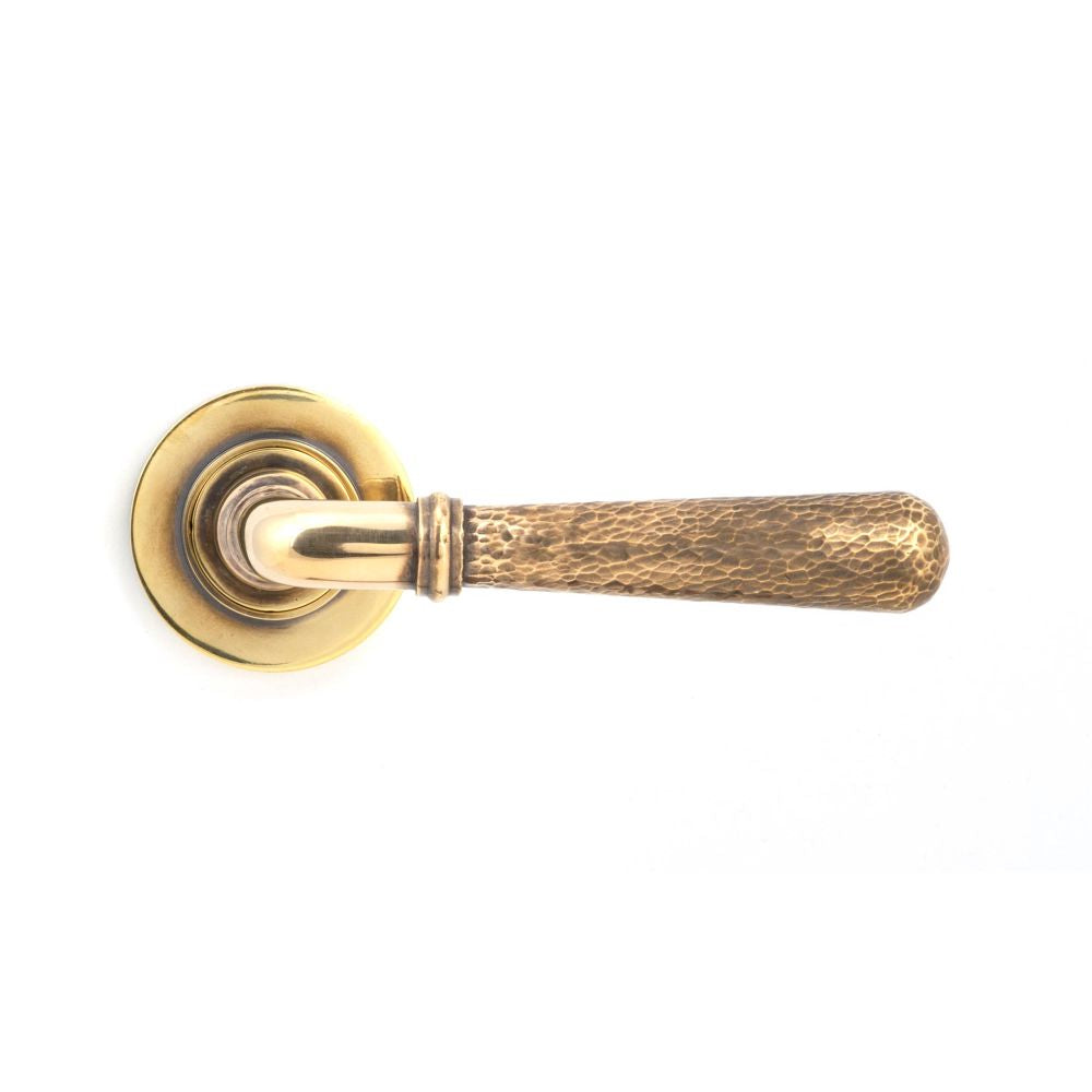 This is an image showing From The Anvil - Aged Brass Hammered Newbury Lever on Rose Set (Plain) available from trade door handles, quick delivery and discounted prices