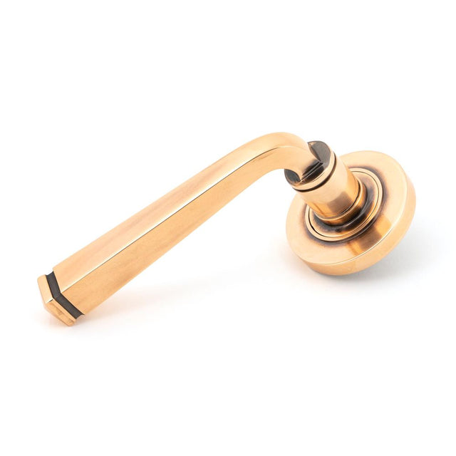 This is an image showing From The Anvil - Polished Bronze Avon Round Lever on Rose Set (Plain) available from trade door handles, quick delivery and discounted prices