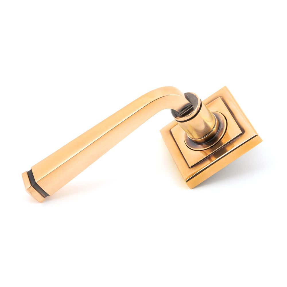 This is an image showing From The Anvil - Polished Bronze Avon Round Lever on Rose Set (Square) available from trade door handles, quick delivery and discounted prices