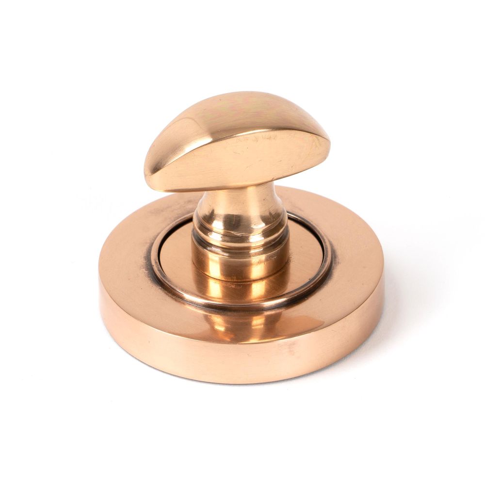 This is an image showing From The Anvil - Polished Bronze Round Thumbturn Set (Plain) available from trade door handles, quick delivery and discounted prices