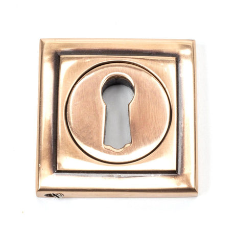 This is an image showing From The Anvil - Polished Bronze Round Escutcheon (Square) available from trade door handles, quick delivery and discounted prices