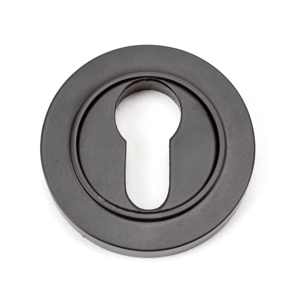 This is an image showing From The Anvil - Aged Bronze Round Euro Escutcheon (Plain) available from trade door handles, quick delivery and discounted prices