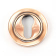 This is an image showing From The Anvil - Polished Bronze Round Euro Escutcheon (Plain) available from trade door handles, quick delivery and discounted prices