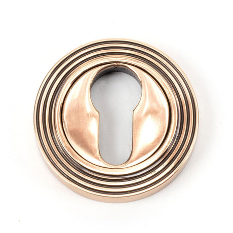 This is an image showing From The Anvil - Polished Bronze Round Euro Escutcheon (Beehive) available from trade door handles, quick delivery and discounted prices