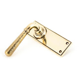 This is an image showing From The Anvil - Aged Brass Hammered Newbury Lever Latch Set available from trade door handles, quick delivery and discounted prices