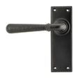 This is an image showing From The Anvil - Aged Bronze Hammered Newbury Lever Latch Set available from trade door handles, quick delivery and discounted prices