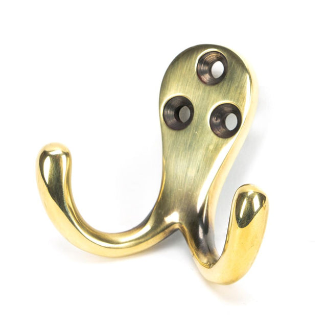 This is an image showing From The Anvil - Aged Brass Celtic Double Robe Hook available from trade door handles, quick delivery and discounted prices