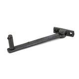 This is an image showing From The Anvil - Beeswax 6" Roller Arm Stay available from trade door handles, quick delivery and discounted prices