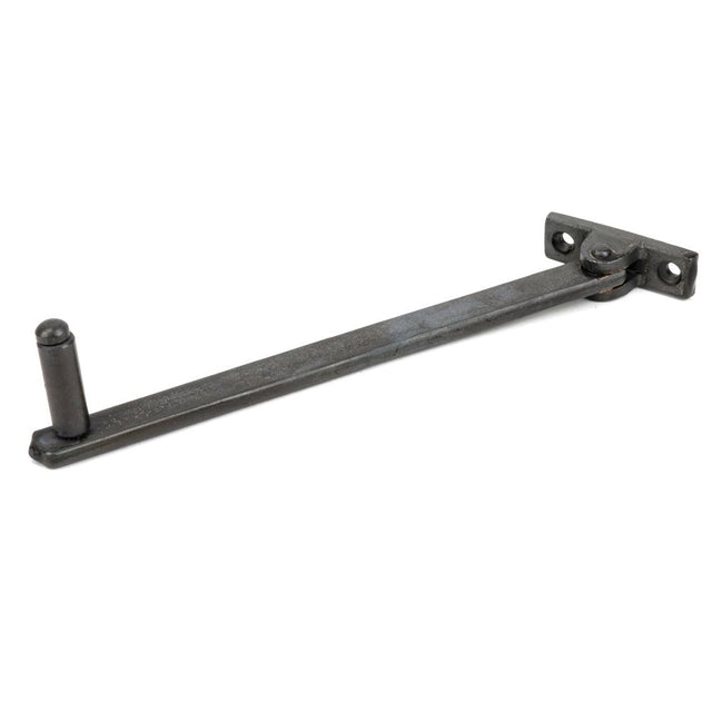 This is an image showing From The Anvil - Beeswax 8" Roller Arm Stay available from trade door handles, quick delivery and discounted prices