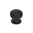 This is an image showing From The Anvil - Matt Black Beehive Cabinet Knob 30mm available from trade door handles, quick delivery and discounted prices