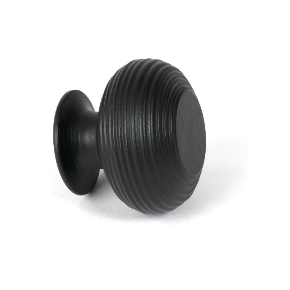 This is an image showing From The Anvil - Matt Black Beehive Cabinet Knob 40mm available from trade door handles, quick delivery and discounted prices