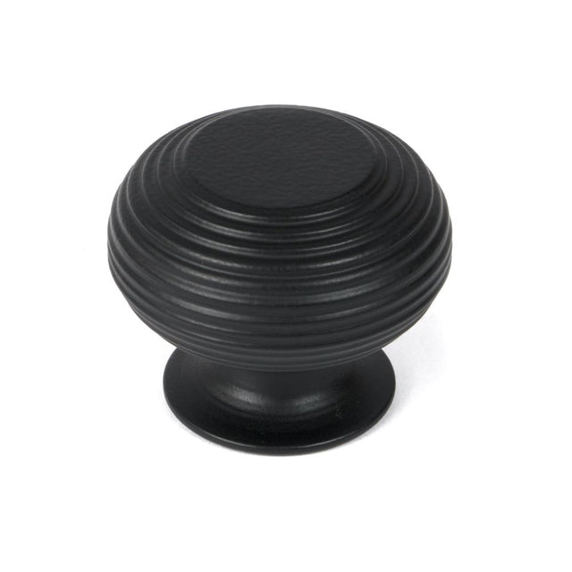 This is an image showing From The Anvil - Matt Black Beehive Cabinet Knob 40mm available from trade door handles, quick delivery and discounted prices