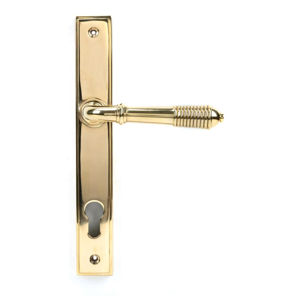 This is an image showing From The Anvil - Polished Brass Reeded Slimline Lever Espag. Lock Set available from trade door handles, quick delivery and discounted prices