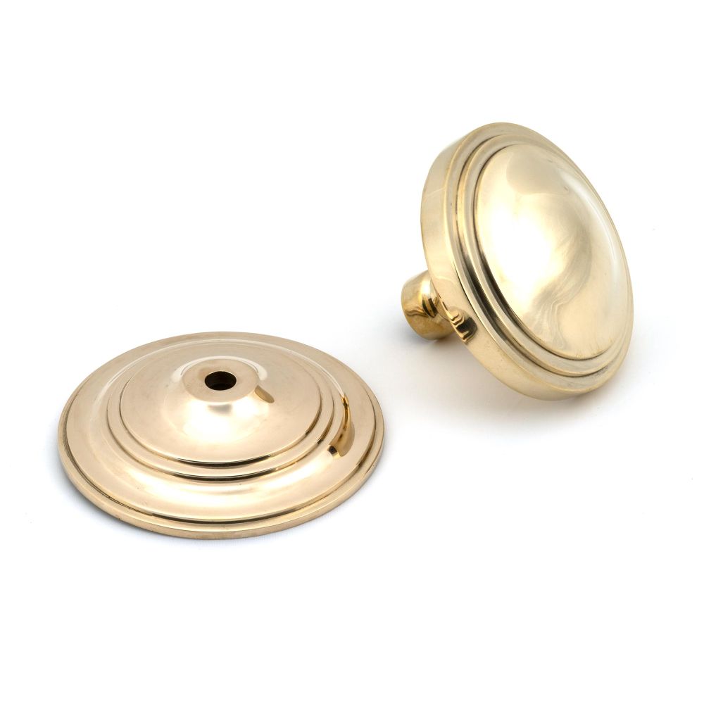 This is an image showing From The Anvil - Polished Brass Art Deco Centre Door Knob available from trade door handles, quick delivery and discounted prices