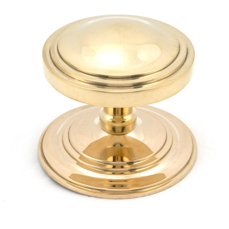 This is an image showing From The Anvil - Polished Brass Art Deco Centre Door Knob available from trade door handles, quick delivery and discounted prices