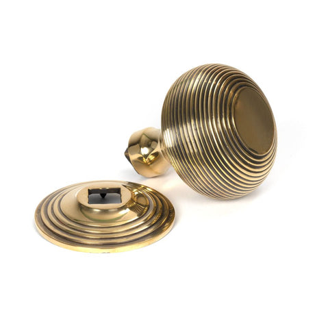 This is an image showing From The Anvil - Aged Brass Beehive Centre Door Knob available from trade door handles, quick delivery and discounted prices