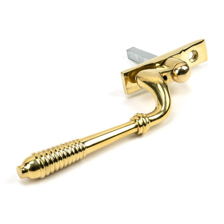 This is an image showing From The Anvil - Polished Brass Reeded Espag - RH available from trade door handles, quick delivery and discounted prices