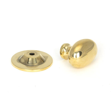 This is an image showing From The Anvil - Aged Brass Oval Cabinet Knob 33mm available from trade door handles, quick delivery and discounted prices