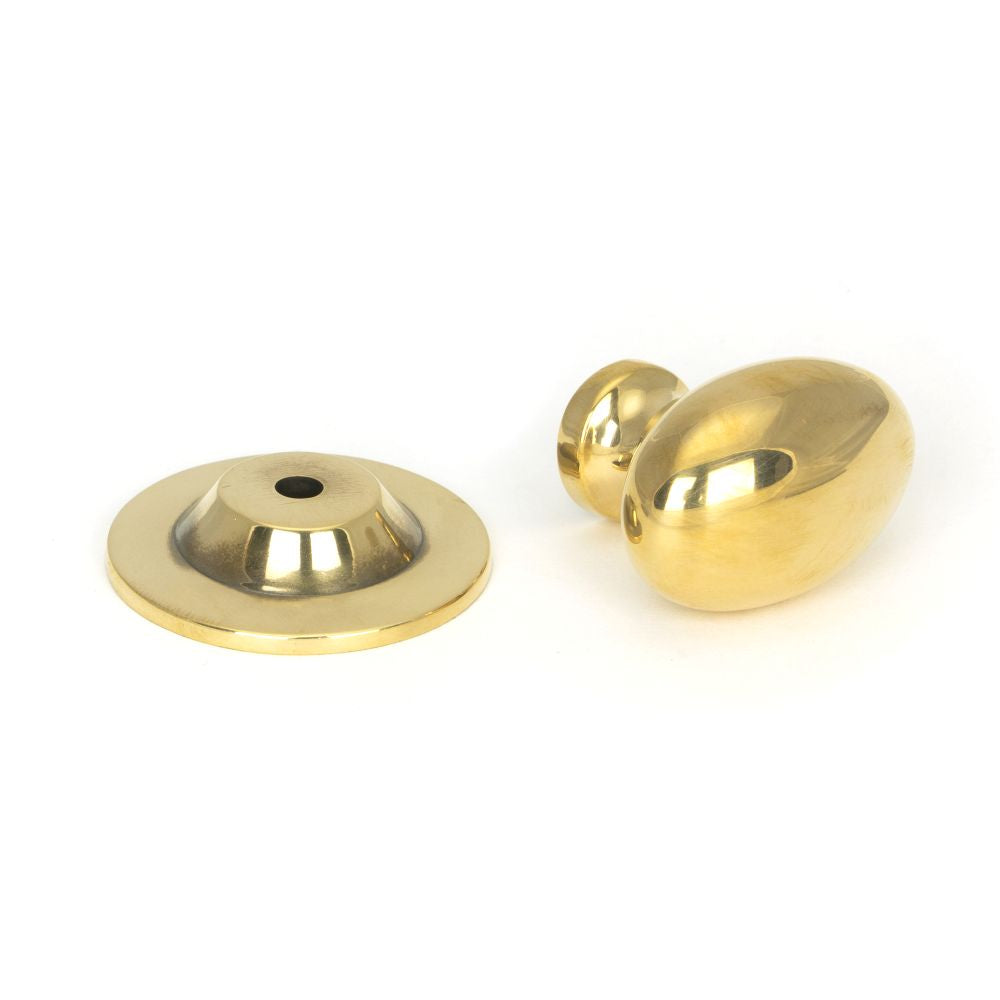 This is an image showing From The Anvil - Aged Brass Oval Cabinet Knob 40mm available from trade door handles, quick delivery and discounted prices
