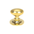 This is an image showing From The Anvil - Aged Brass Oval Cabinet Knob 40mm available from trade door handles, quick delivery and discounted prices