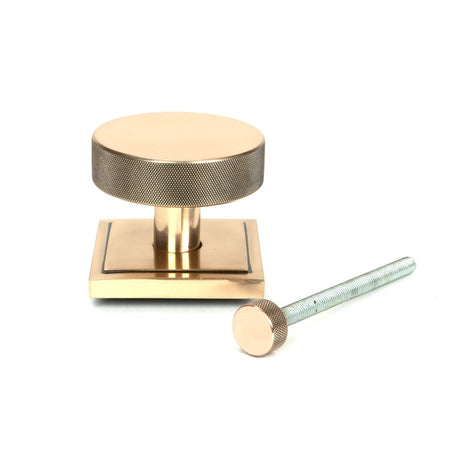 This is an image showing From The Anvil - Polished Bronze Brompton Centre Door Knob (Square) available from trade door handles, quick delivery and discounted prices