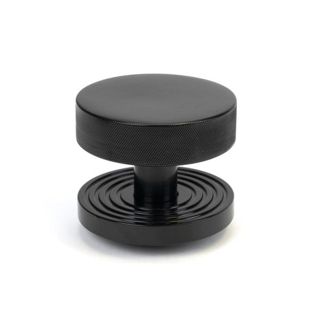 This is an image showing From The Anvil - Black Brompton Centre Door Knob (Beehive) available from trade door handles, quick delivery and discounted prices