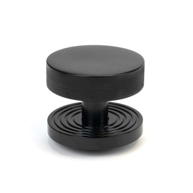 This is an image showing From The Anvil - Black Brompton Centre Door Knob (Beehive) available from trade door handles, quick delivery and discounted prices