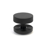 This is an image showing From The Anvil - Matt Black Brompton Centre Door Knob (Beehive) available from trade door handles, quick delivery and discounted prices