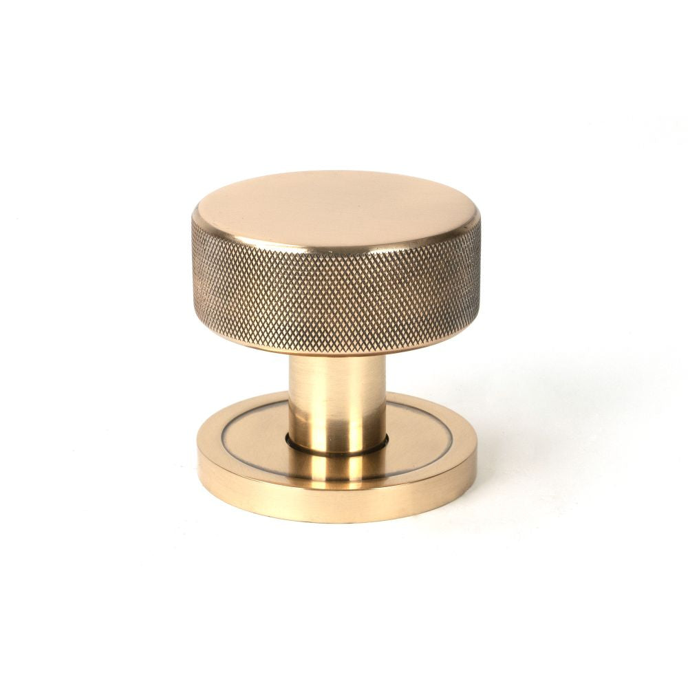 This is an image showing From The Anvil - Polished Bronze Brompton Mortice/Rim Knob Set (Plain) available from trade door handles, quick delivery and discounted prices