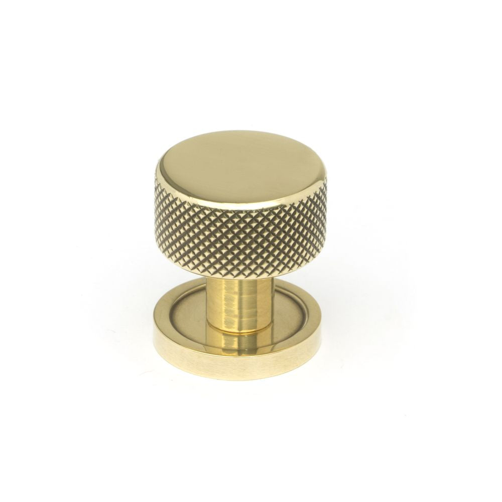 This is an image showing From The Anvil - Aged Brass Brompton Cabinet Knob - 25mm (Plain) available from trade door handles, quick delivery and discounted prices