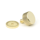 This is an image showing From The Anvil - Polished Brass Brompton Cabinet Knob - 32mm (Plain) available from trade door handles, quick delivery and discounted prices