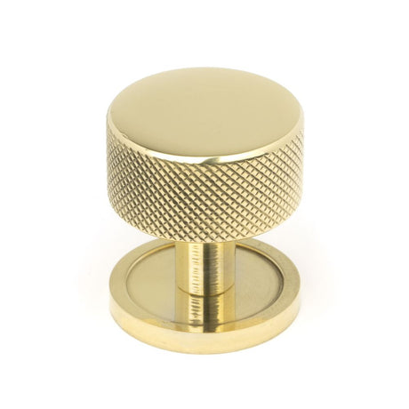 This is an image showing From The Anvil - Polished Brass Brompton Cabinet Knob - 32mm (Plain) available from trade door handles, quick delivery and discounted prices