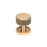 This is an image showing From The Anvil - Polished Bronze Brompton Cabinet Knob - 25mm (Plain) available from trade door handles, quick delivery and discounted prices