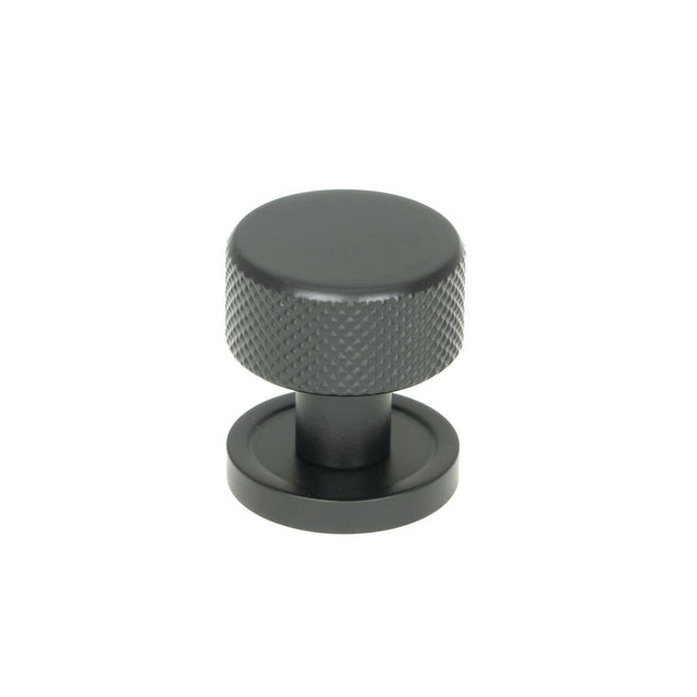 This is an image showing From The Anvil - Matt Black Brompton Cabinet Knob - 25mm (Plain) available from trade door handles, quick delivery and discounted prices