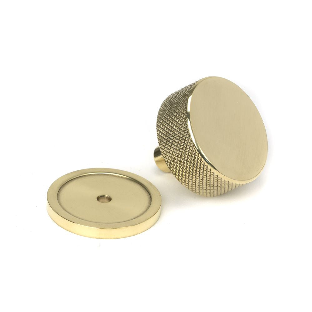 This is an image showing From The Anvil - Polished Brass Brompton Cabinet Knob - 38mm (Plain) available from trade door handles, quick delivery and discounted prices