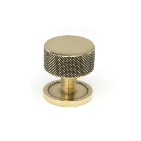 This is an image showing From The Anvil - Aged Brass Brompton Cabinet Knob - 32mm (Plain) available from trade door handles, quick delivery and discounted prices