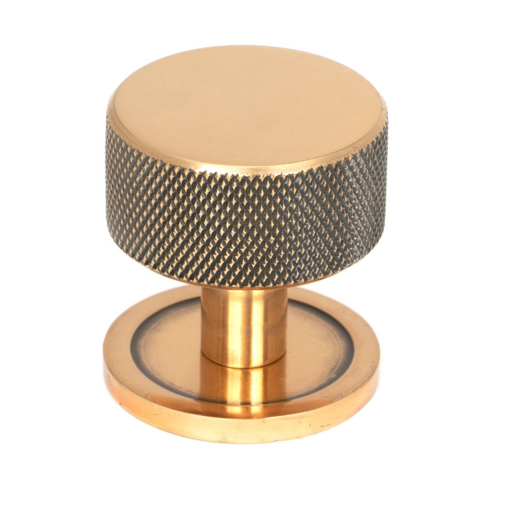 This is an image showing From The Anvil - Polished Bronze Brompton Cabinet Knob - 32mm (Plain) available from trade door handles, quick delivery and discounted prices