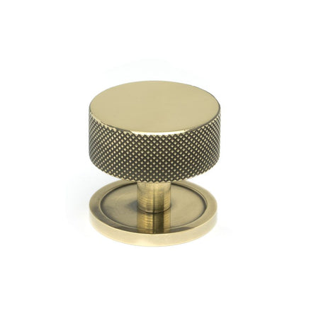 This is an image showing From The Anvil - Aged Brass Brompton Cabinet Knob - 38mm (Plain) available from trade door handles, quick delivery and discounted prices