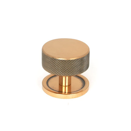 This is an image showing From The Anvil - Polished Bronze Brompton Cabinet Knob - 38mm (Plain) available from trade door handles, quick delivery and discounted prices