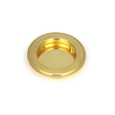 This is an image showing From The Anvil - Polished Brass 75mm Art Deco Round Pull available from trade door handles, quick delivery and discounted prices
