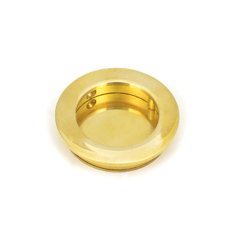 This is an image showing From The Anvil - Polished Brass 60mm Plain Round Pull available from trade door handles, quick delivery and discounted prices