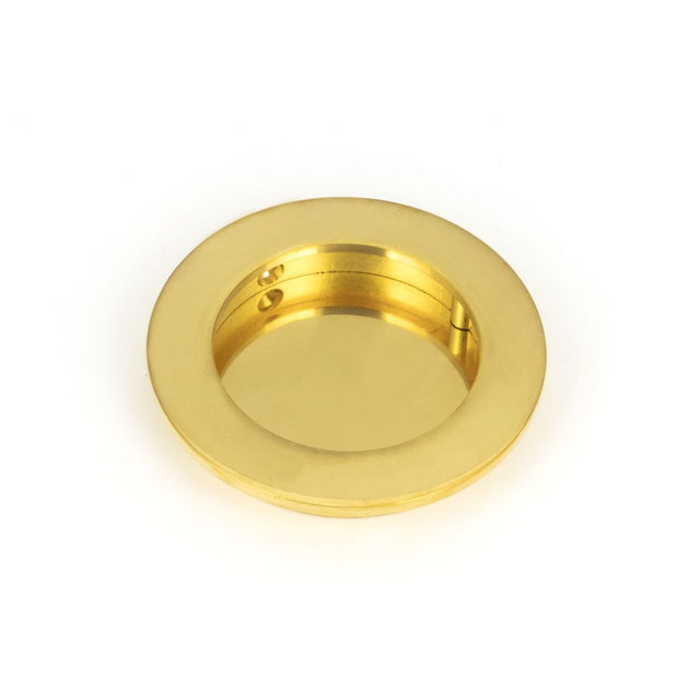 This is an image showing From The Anvil - Polished Brass 75mm Plain Round Pull available from trade door handles, quick delivery and discounted prices