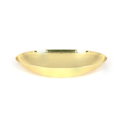 This is an image showing From The Anvil - Hammered Brass Oval Sink available from trade door handles, quick delivery and discounted prices