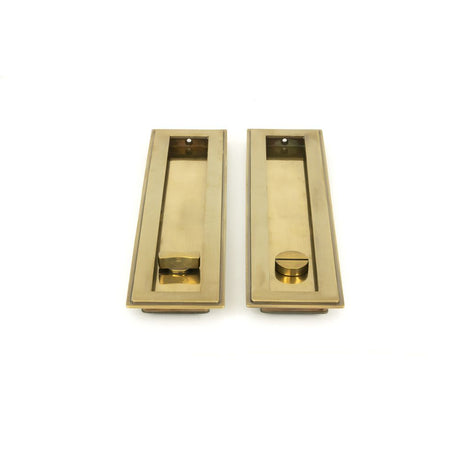 This is an image showing From The Anvil - Aged Brass 250mm Art Deco Rectangular Pull - Privacy Set available from trade door handles, quick delivery and discounted prices