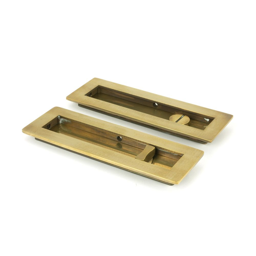 This is an image showing From The Anvil - Aged Brass 175mm Plain Rectangular Pull - Privacy Set available from trade door handles, quick delivery and discounted prices