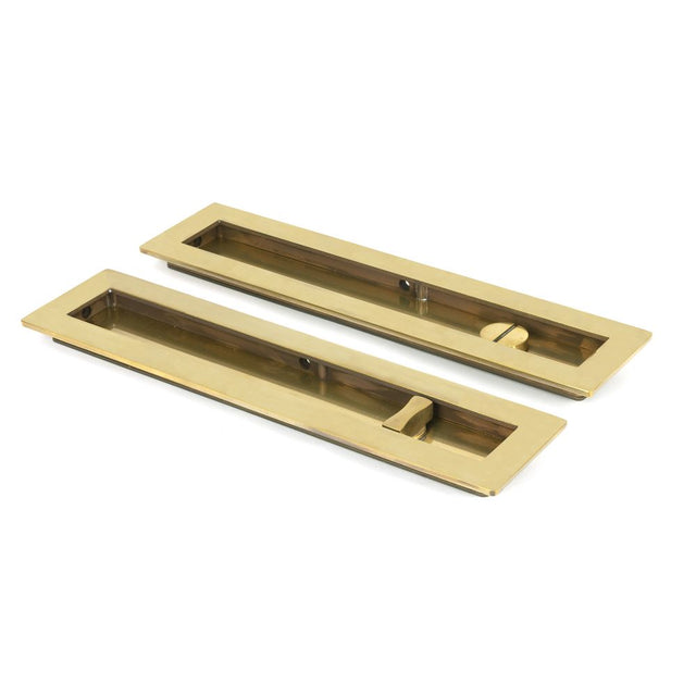 This is an image showing From The Anvil - Aged Brass 250mm Plain Rectangular Pull - Privacy Set available from trade door handles, quick delivery and discounted prices