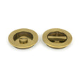 This is an image showing From The Anvil - Aged Brass 75mm Art Deco Round Pull - Privacy Set available from trade door handles, quick delivery and discounted prices