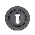 This is an image showing From The Anvil - Matt Black Round Escutcheon (Plain) available from trade door handles, quick delivery and discounted prices